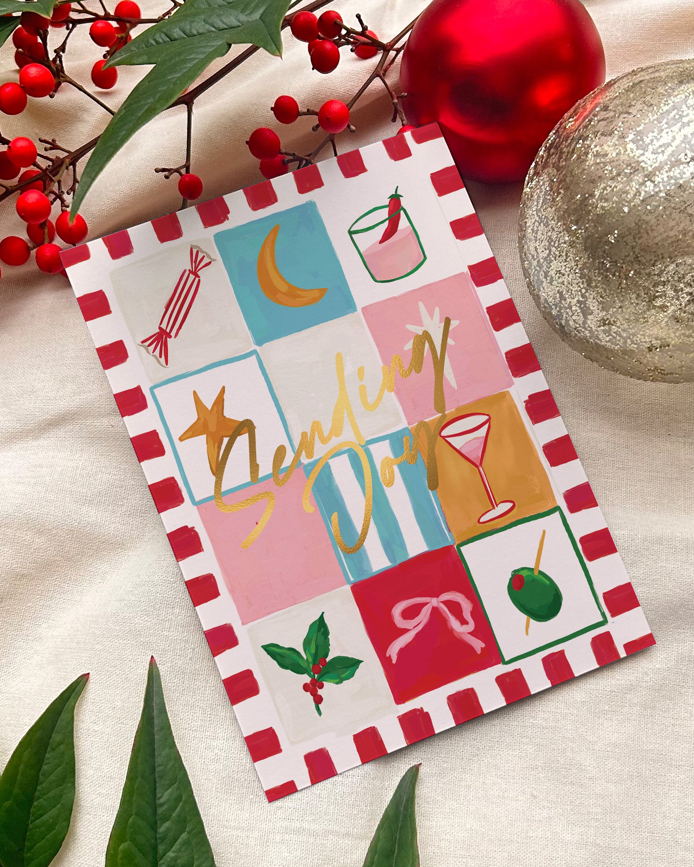 Colorful greeting card with festive design on a light background with Christmas decorations.